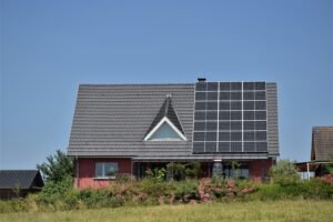 House with solar panels on the roof, symbolizing green technology and sustainability.