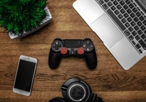 "Gaming controller and tech accessories on a desk, representing the latest in gaming technology."