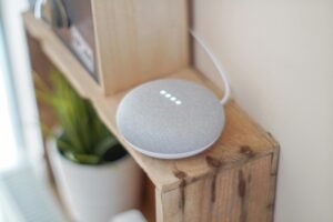 Smart home speaker on a shelf, representing smart home automation.