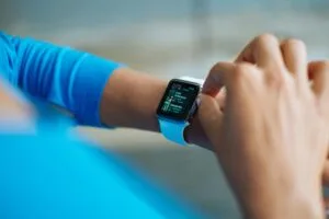 Person wearing a smartwatch, representing wearable tech for fitness and daily tasks.