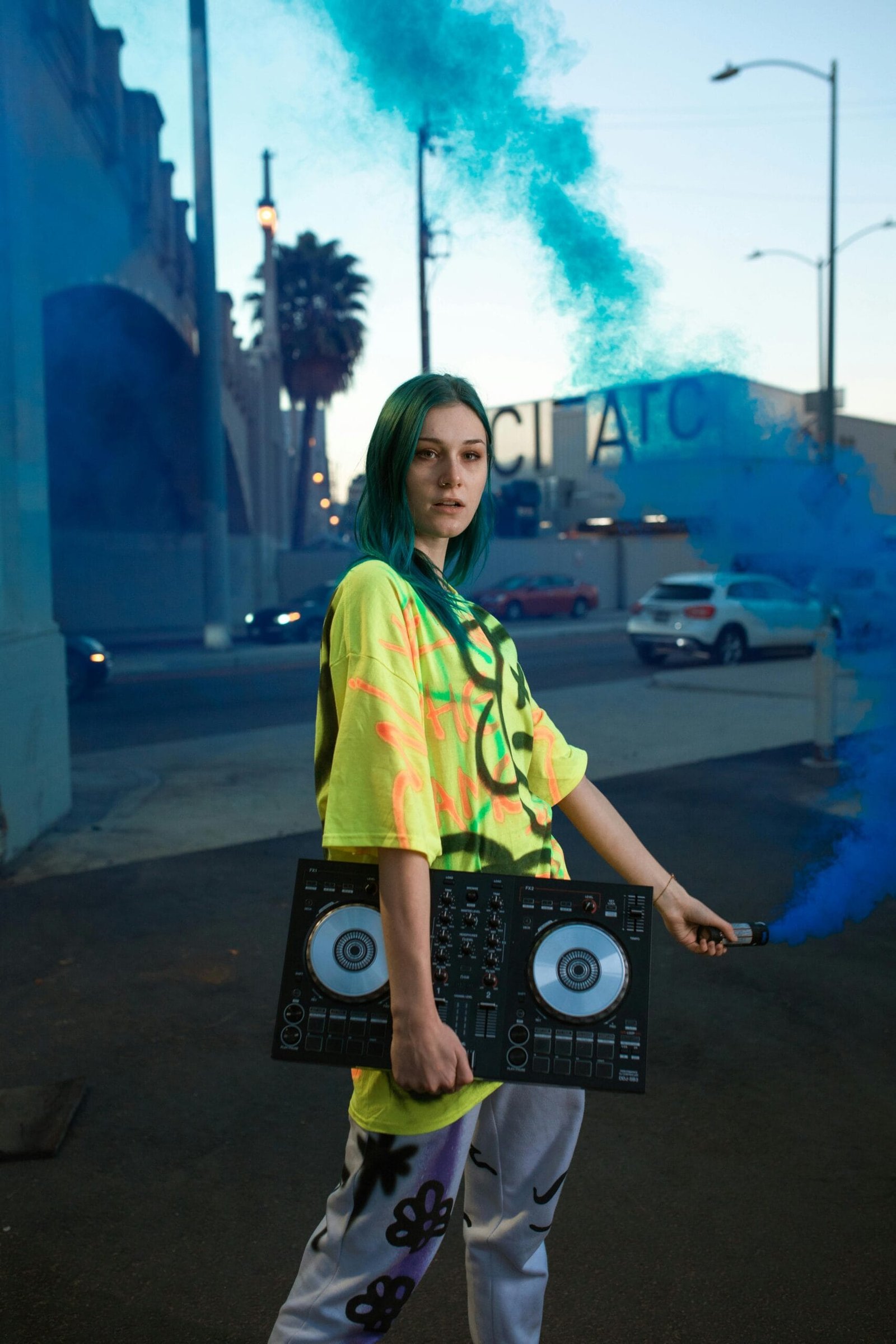 Woman holding DJ equipment, symbolizing the latest in entertainment tech.
