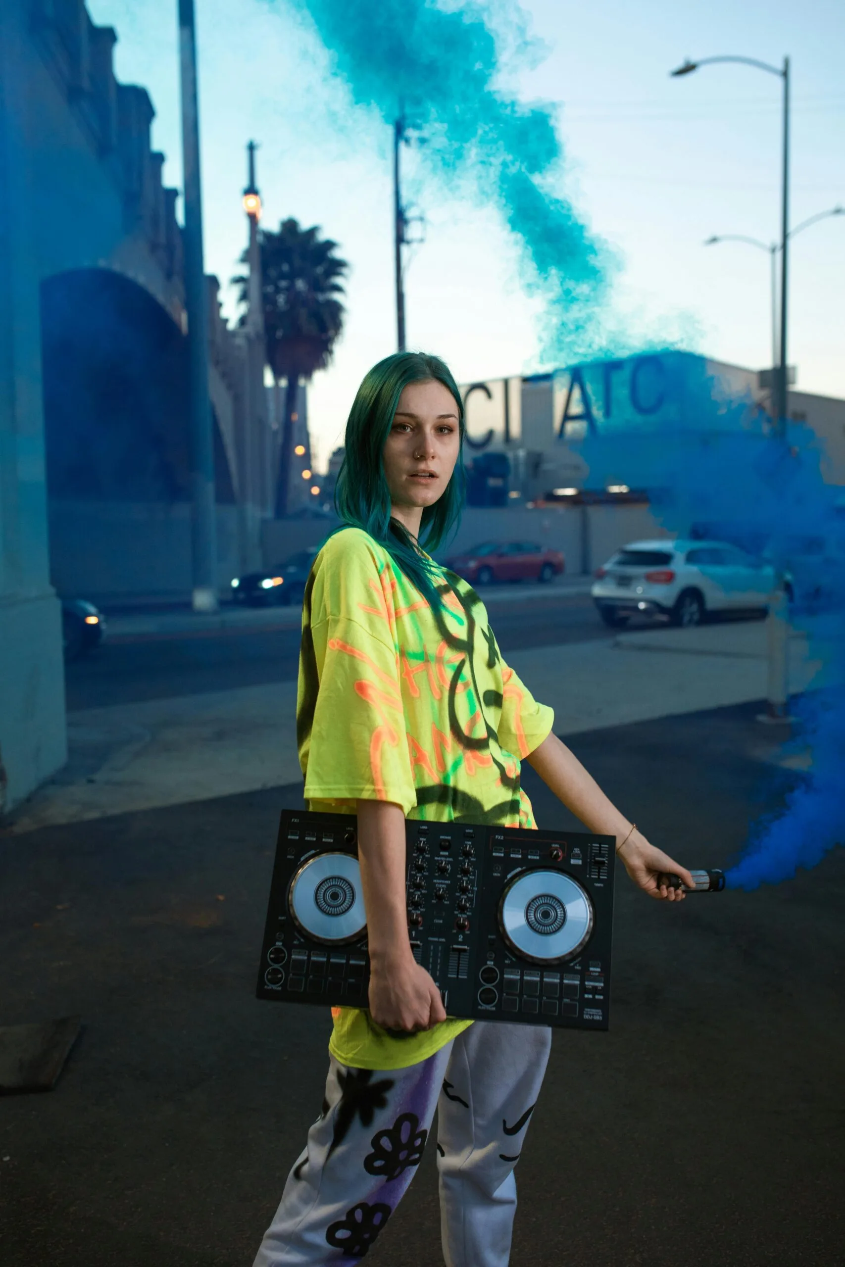 Woman holding DJ equipment, symbolizing the latest in entertainment tech.