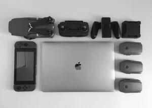 Collection of tech devices, including a laptop and gaming controllers, symbolizing the best tech for streamlining.