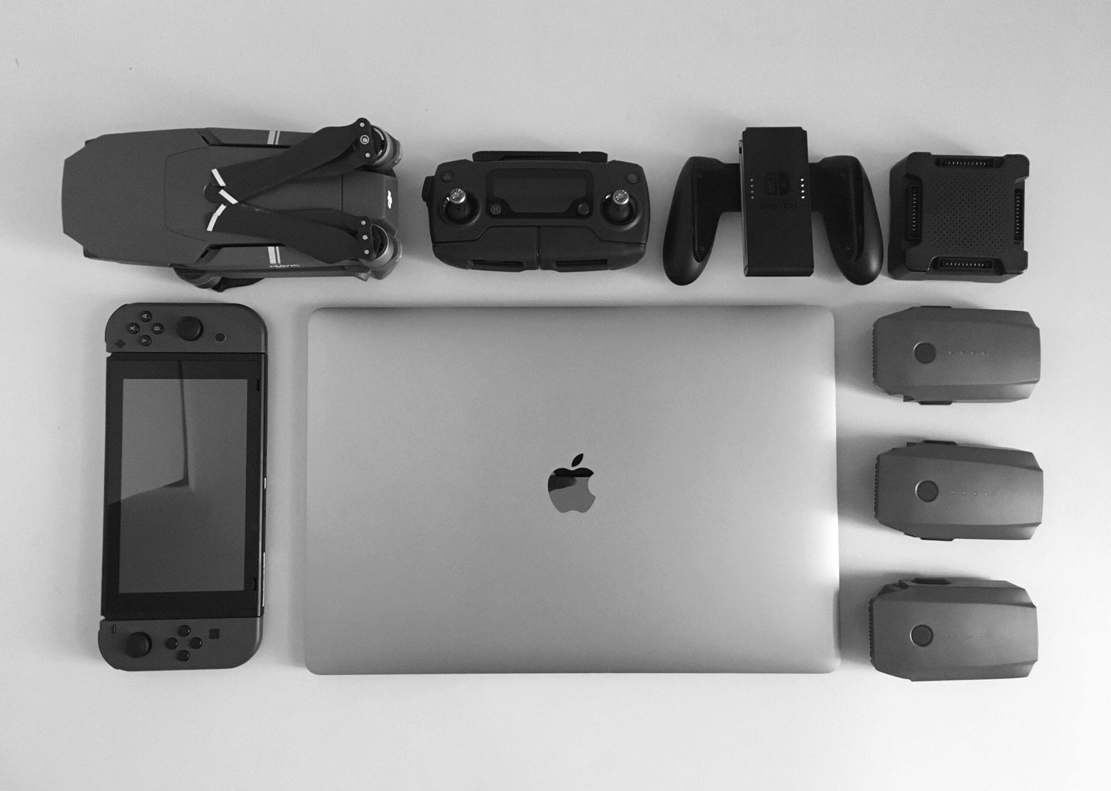 Collection of tech devices, including a laptop and gaming controllers, symbolizing the best tech for streamlining.